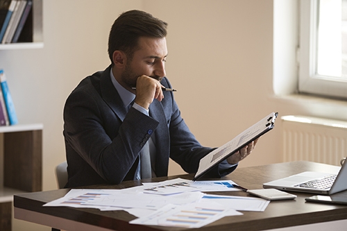 Businessman working with graph data at office Businessman working with graph data at office