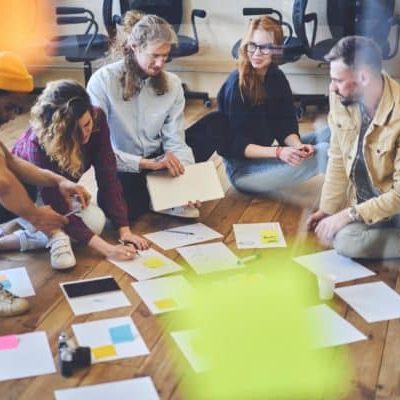 Dream team of hipster student collaborating preparing coursework together making planning and analyzing information, talented male and female colleagues creating business plan brainstorming on meeting